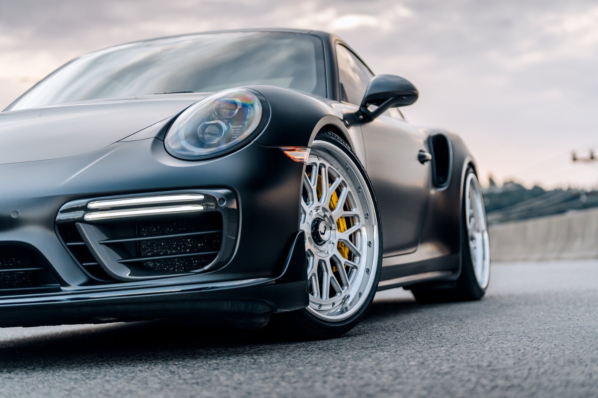 Sleek black Porsche 911 Turbo S with showroom-perfect mirror finish, showcasing premium car detailing results